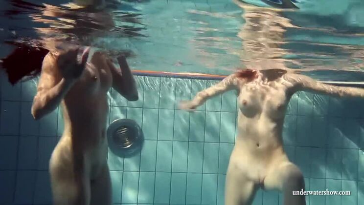 Mia and Petra undress eachother in the swimmingpool