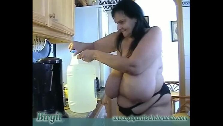 Granny with Giant saggy udders cooks in topless. Massive h. Cow Udders